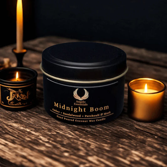 Midnight Boom candle with amber, sandalwood, and patchouli scents, hand-poured coconut wax, displayed on a wooden table.