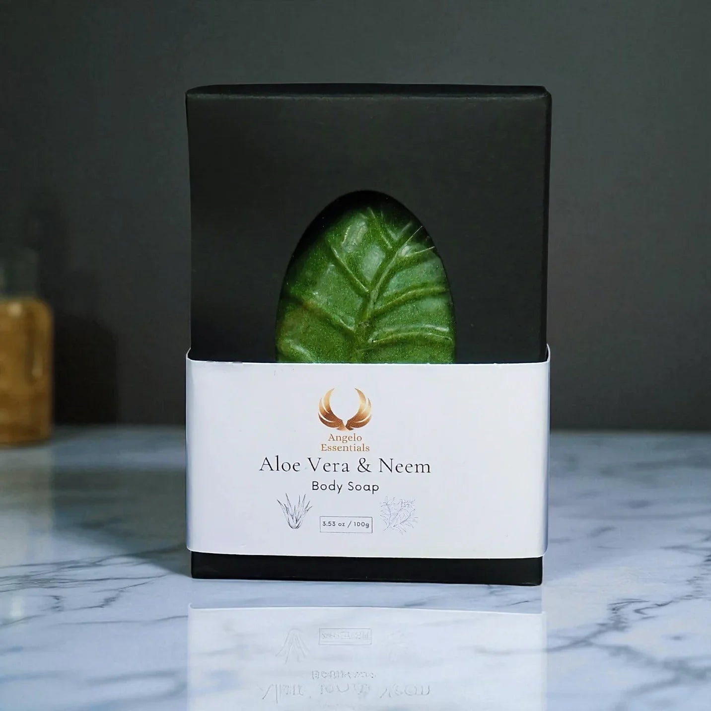 Aloe Vera & Neem Body Soap in eco-friendly packaging on a marble countertop. Nourishing and refreshing.